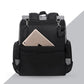 sac à dos à langer noir vu de dos avec une poche pour tablette