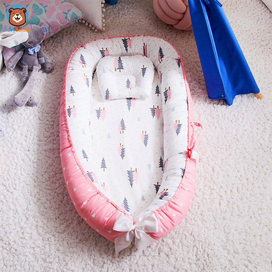 réducteur de lit bébé - rose